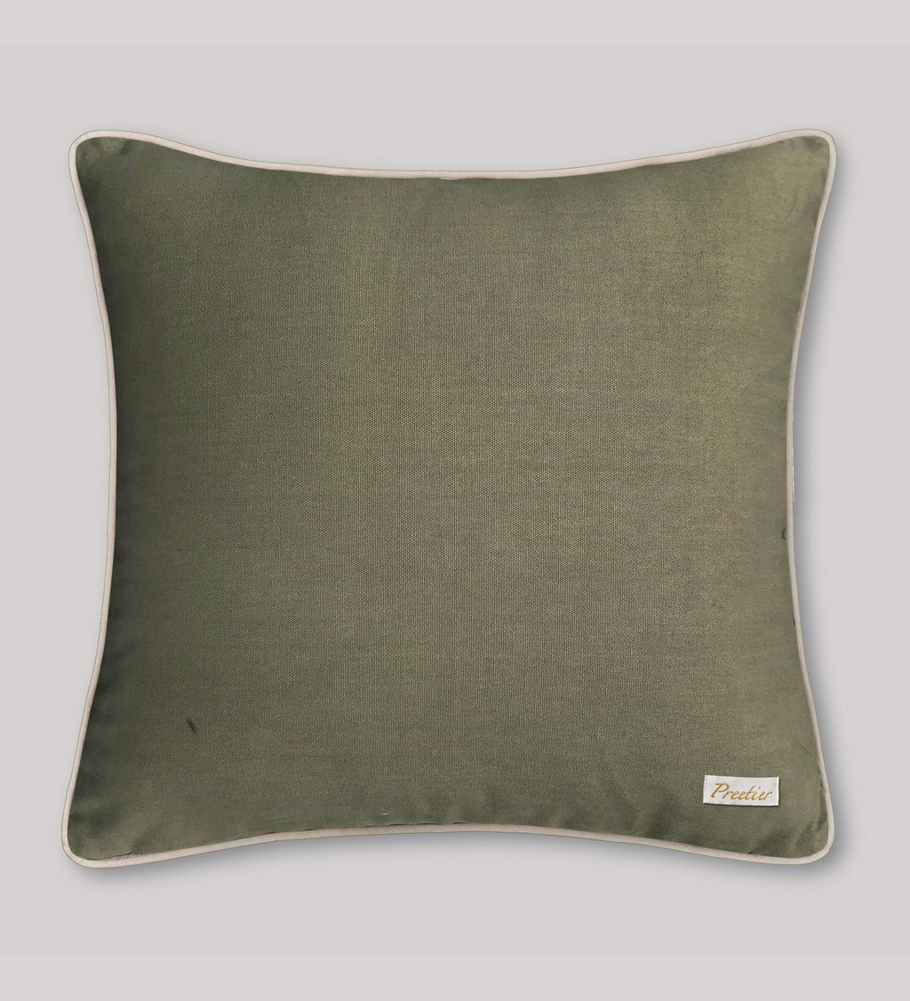 Green pillow with a brand label on a light gray background