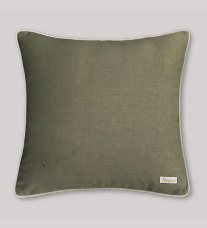 Green pillow with a brand label on a light gray background