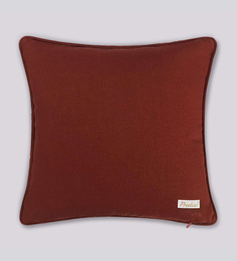 Brown pillow with a brand label on a light gray background