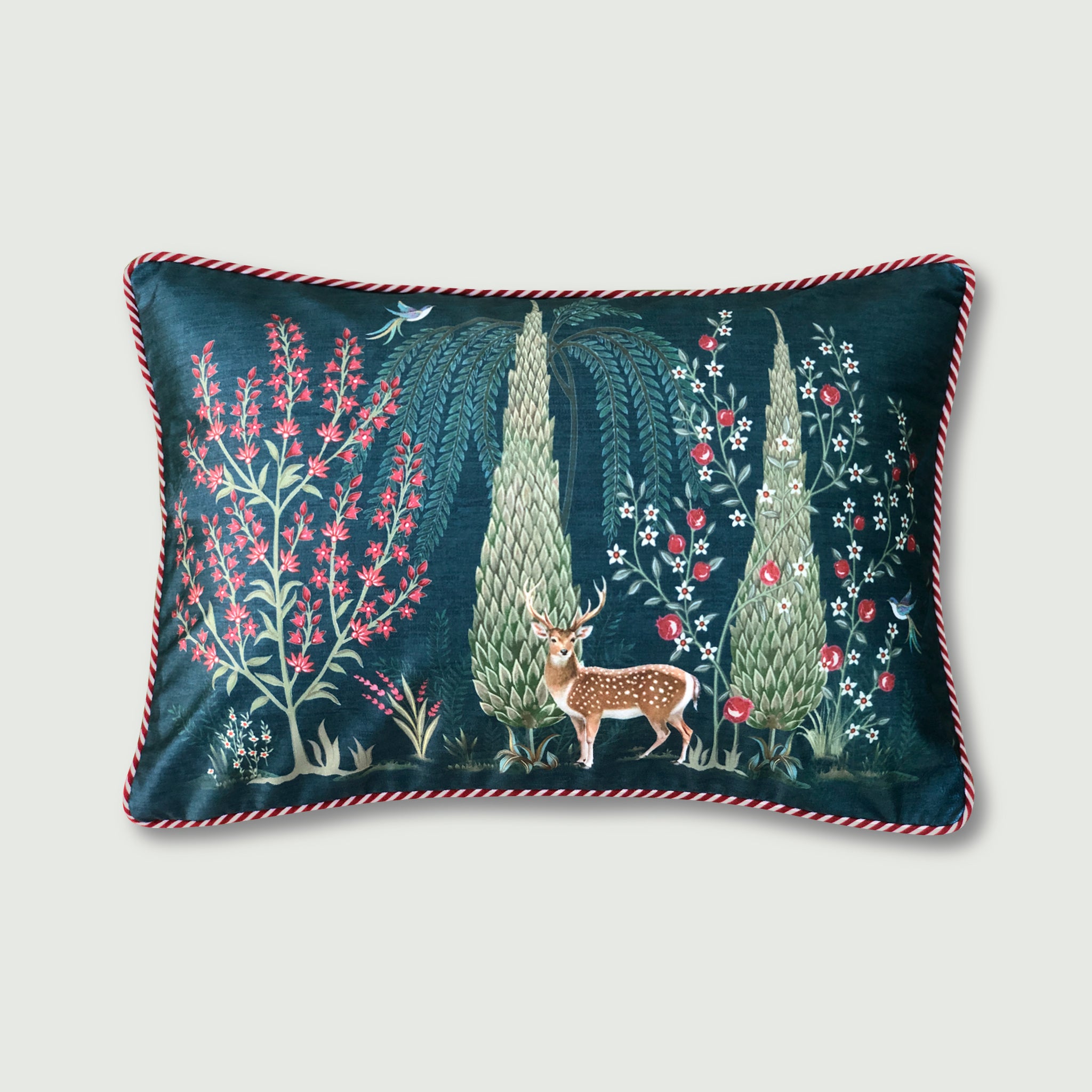 Teal Mughal Garden 14x20 lumbar cushion cover featuring a white spotted deer and green cypress trees with red and white striped piping edges.