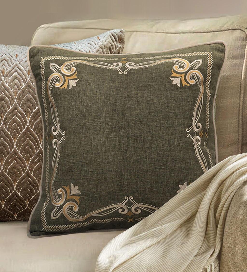 Elegant green pillow with ornate gold embroidery, decorative throw pillow for stylish home interiors.
