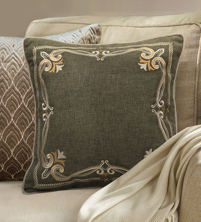 Elegant green pillow with ornate gold embroidery, decorative throw pillow for stylish home interiors.
