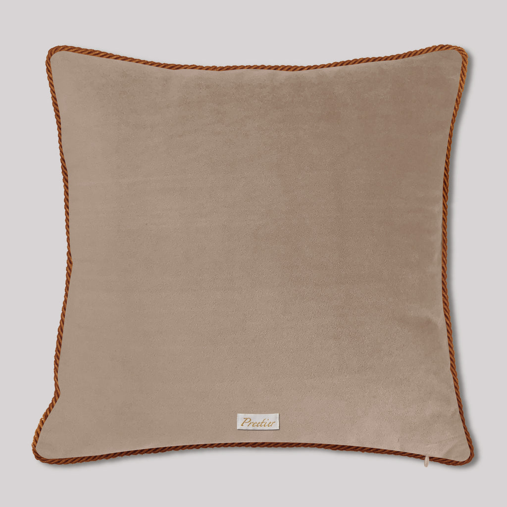 Beige pillow with brown trim on a light gray background
