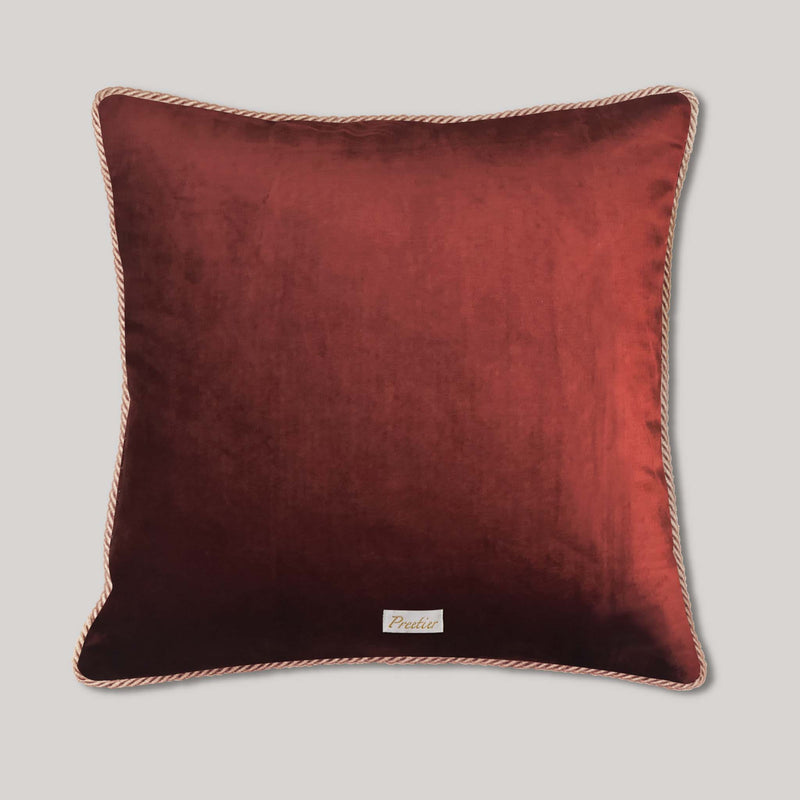 Rust velvet cushion handmade with detailed landscape floral embroidery, showcasing embroidery art as a room accent pillow for warm, earthy home decoration.