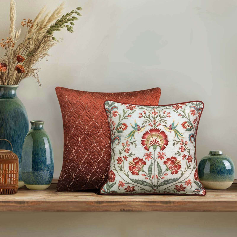 Luxury handcrafted rust cushion cover featuring intricate floral print in red, pink, and teal hues — Rang Baagh design perfect for elevating living room or bedroom décor.