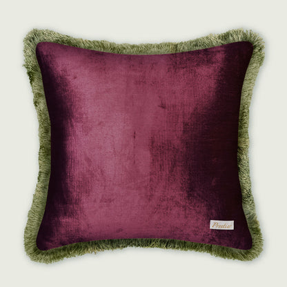Purple pillow with green fringes on a white background
